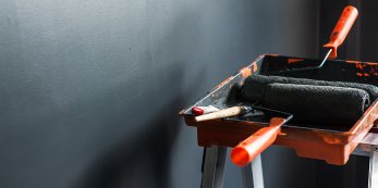 Painting roller in a bucket